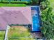 Aerial view of a private screened pool and spa with lush backyard landscaping at 112 Tuscany Bend St, Daytona Beach, FL 32117