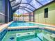 Enclosed pool featuring clear blue water, a jacuzzi, and a deck; perfect for relaxing and entertaining guests at 112 Tuscany Bend St, Daytona Beach, FL 32117