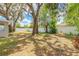Spacious backyard featuring mature trees, a white fence, and ample space at 118 N Sunland Dr, Sanford, FL 32773