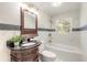 Elegant bathroom featuring decorative vanity, marble tiling and a shower/tub combination at 118 N Sunland Dr, Sanford, FL 32773