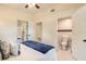 Cozy bedroom with ensuite bathroom, natural lighting and a modern ceiling fan at 118 N Sunland Dr, Sanford, FL 32773