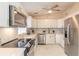 Modern kitchen featuring stainless steel appliances, white cabinets, and marble countertops at 118 N Sunland Dr, Sanford, FL 32773