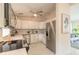 Modern kitchen featuring stainless steel appliances, white cabinets, and marble countertops at 118 N Sunland Dr, Sanford, FL 32773