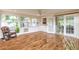 Bright sunroom with lots of windows, wood floors, and access to the back yard at 118 N Sunland Dr, Sanford, FL 32773