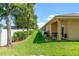Spacious backyard with well-maintained lawn, shaded by mature trees, and a covered patio for relaxation and grilling at 118 Tuscany Villas Dr, Edgewater, FL 32141