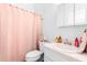 Cozy bathroom features a single vanity with a tub and shower featuring a pink curtain at 118 Tuscany Villas Dr, Edgewater, FL 32141