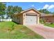 Charming single-story home with a well-manicured lawn, paved driveway, and a two-car garage for convenience at 118 Tuscany Villas Dr, Edgewater, FL 32141