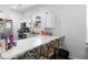 Efficient white kitchen with breakfast bar, stainless steel appliances, and ample counter space at 118 Tuscany Villas Dr, Edgewater, FL 32141