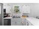 Efficient white kitchen with stainless steel appliances and ample countertop area at 118 Tuscany Villas Dr, Edgewater, FL 32141
