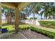 Relaxing covered patio area with brick pavers and view of the fenced in backyard at 118 Tuscany Villas Dr, Edgewater, FL 32141