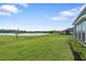 Large grassy backyard overlooking a serene lake at 141 Mosaic Blvd, Daytona Beach, FL 32124