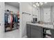 Well-organized bathroom featuring granite countertops, ample storage, and adjacent walk-in closet for ultimate convenience at 141 Mosaic Blvd, Daytona Beach, FL 32124