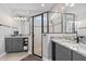 Modern bathroom with granite countertops, double vanities, and a walk-in shower featuring designer tile accents at 141 Mosaic Blvd, Daytona Beach, FL 32124