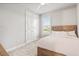 Comfortable bedroom features neutral colors, double door closet and a window with plantation shutters for ample natural light at 141 Mosaic Blvd, Daytona Beach, FL 32124
