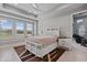 Bright main bedroom features tray ceiling, plantation shutters, and en-suite bathroom access for added privacy at 141 Mosaic Blvd, Daytona Beach, FL 32124