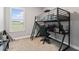 Bedroom with lofted bed frame, computer setup, and large window at 141 Mosaic Blvd, Daytona Beach, FL 32124