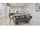 Open-concept dining area featuring stylish lighting and a view into the modern kitchen with stainless steel appliances at 141 Mosaic Blvd, Daytona Beach, FL 32124