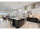 Bright kitchen with an island, stainless steel appliances, wine storage, and a seamless connection to the living area at 141 Mosaic Blvd, Daytona Beach, FL 32124