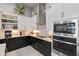 Stylish kitchen with black and white cabinetry, stainless steel appliances, and modern lighting at 141 Mosaic Blvd, Daytona Beach, FL 32124