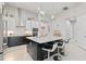 Modern kitchen featuring an island with seating, stainless steel appliances, and stylish pendant lighting at 141 Mosaic Blvd, Daytona Beach, FL 32124