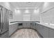 Modern kitchenette features sleek cabinetry, stainless steel appliances, and ample counter space for convenience at 141 Mosaic Blvd, Daytona Beach, FL 32124