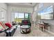 Bright living room with black leather couches and outdoor view at 141 Mosaic Blvd, Daytona Beach, FL 32124