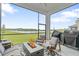 Covered screened lanai with fire pit, outdoor seating, and lake view at 141 Mosaic Blvd, Daytona Beach, FL 32124