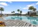 Community swimming pool with palm trees and lounge chairs at 141 Mosaic Blvd, Daytona Beach, FL 32124