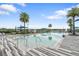 Resort-style community pool surrounded by palm trees and lounge areas provides a relaxing oasis at 141 Mosaic Blvd, Daytona Beach, FL 32124
