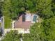 An aerial view of a beautiful single-Gathering home with a screened-in pool surrounded by lush greenery at 1516 Arrowhead Trl, Enterprise, FL 32725