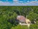 Beautiful aerial view of property with lush, green surrounding trees at 1516 Arrowhead Trl, Enterprise, FL 32725