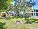The expansive backyard has mature trees with a fire pit creating a perfect outdoor retreat for gatherings at 1516 Arrowhead Trl, Enterprise, FL 32725