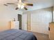 Comfortable bedroom with a gray quilt, lots of closet space, and natural light, creating a relaxing atmosphere at 1516 Arrowhead Trl, Enterprise, FL 32725