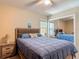 Bedroom with comfortable bed, mirrored closet doors, and two windows providing natural light at 1516 Arrowhead Trl, Enterprise, FL 32725
