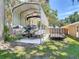 Boat and trailer parked under metal carport and large shade trees at 1516 Arrowhead Trl, Enterprise, FL 32725