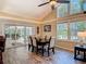 Spacious dining room with vaulted ceiling, wood-look floors, and access to a screened-in patio via sliding glass doors at 1516 Arrowhead Trl, Enterprise, FL 32725