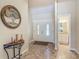 Inviting foyer with tile flooring, decorative tree art, and double front doors with decorative glass at 1516 Arrowhead Trl, Enterprise, FL 32725