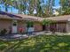 Front exterior showing beautiful plants and a manicured lawn at 1516 Arrowhead Trl, Enterprise, FL 32725