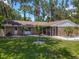 Well-maintained home with lush lawn, mature trees, and charming landscaping details at 1516 Arrowhead Trl, Enterprise, FL 32725