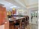 Kitchen island with seating, granite counters, and dark wood cabinets at 1516 Arrowhead Trl, Enterprise, FL 32725