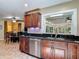 Gourmet kitchen with granite counters, stainless appliances, and dark wood cabinetry at 1516 Arrowhead Trl, Enterprise, FL 32725