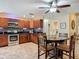 Well-appointed kitchen and dining area features matching dark wood cabinetry and modern appliances at 1516 Arrowhead Trl, Enterprise, FL 32725