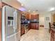 Kitchen with stainless appliances, granite counters, dark cabinets, and tile floor at 1516 Arrowhead Trl, Enterprise, FL 32725
