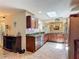 Large, open kitchen with dark wood cabinets, granite countertops and stainless steel appliances at 1516 Arrowhead Trl, Enterprise, FL 32725