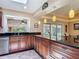 Bright kitchen with granite counters and stainless steel appliances overlooks a sunny backyard and pool at 1516 Arrowhead Trl, Enterprise, FL 32725