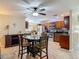 Open-concept kitchen with adjacent dining area features modern appliances and tile flooring at 1516 Arrowhead Trl, Enterprise, FL 32725