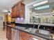 Granite counters, stainless steel appliances and dark wood cabinets make this kitchen shine at 1516 Arrowhead Trl, Enterprise, FL 32725