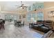 Open-concept living space with abundant natural light and access to outdoor patio at 1516 Arrowhead Trl, Enterprise, FL 32725