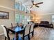 Open-concept living and dining room showcases wood-look floors, vaulted ceilings, and plentiful natural light at 1516 Arrowhead Trl, Enterprise, FL 32725