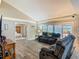 Open-concept living area with gray couches and view of screened lanai at 1516 Arrowhead Trl, Enterprise, FL 32725